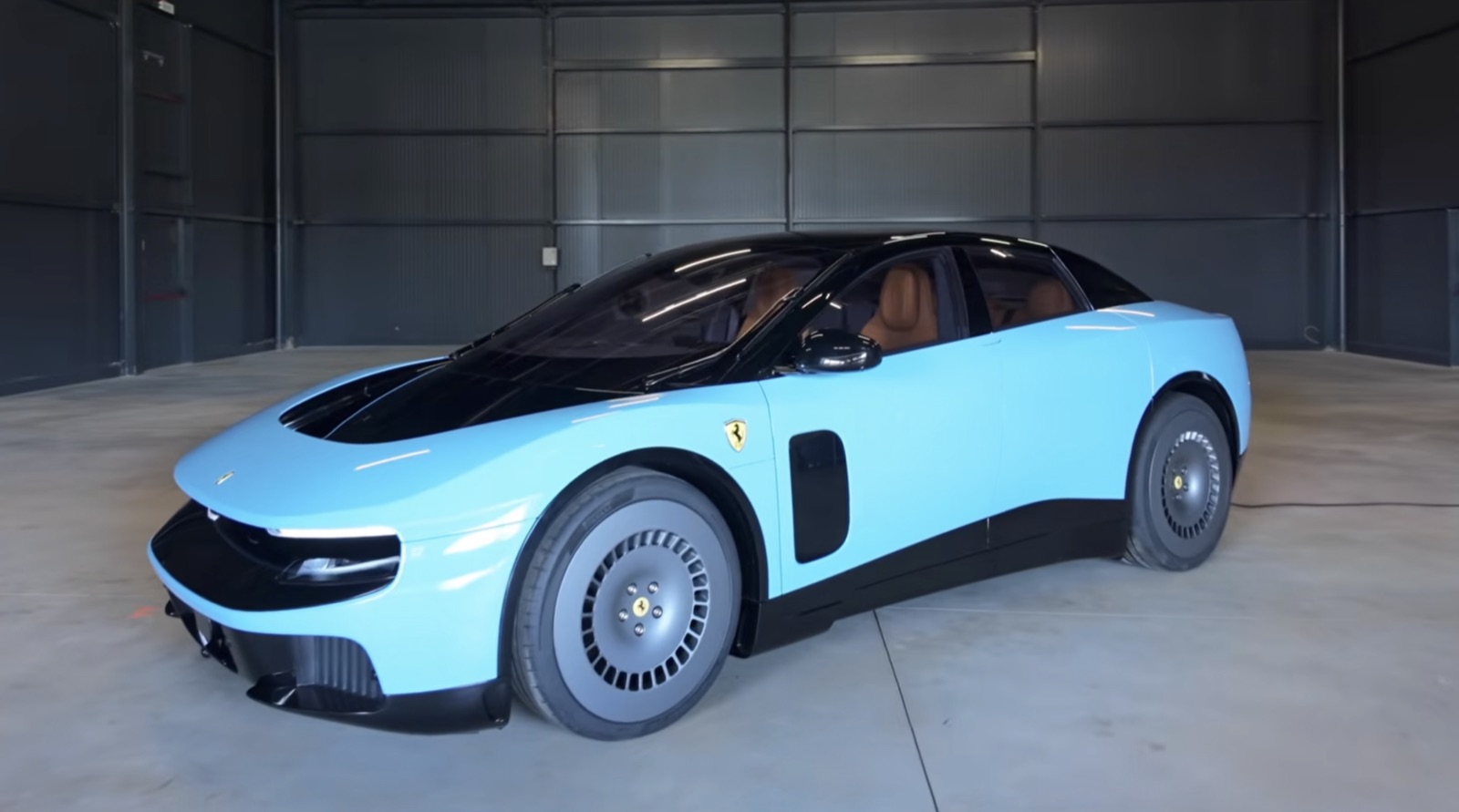 The Ferrari Luce, a light-blue electric sedan, parked in a garage